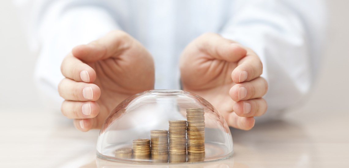 hands protecting money kept safe in bubble