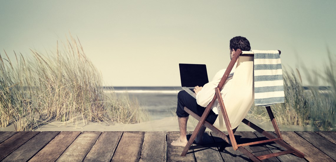 man-working-on-a-beach-in-deckchair