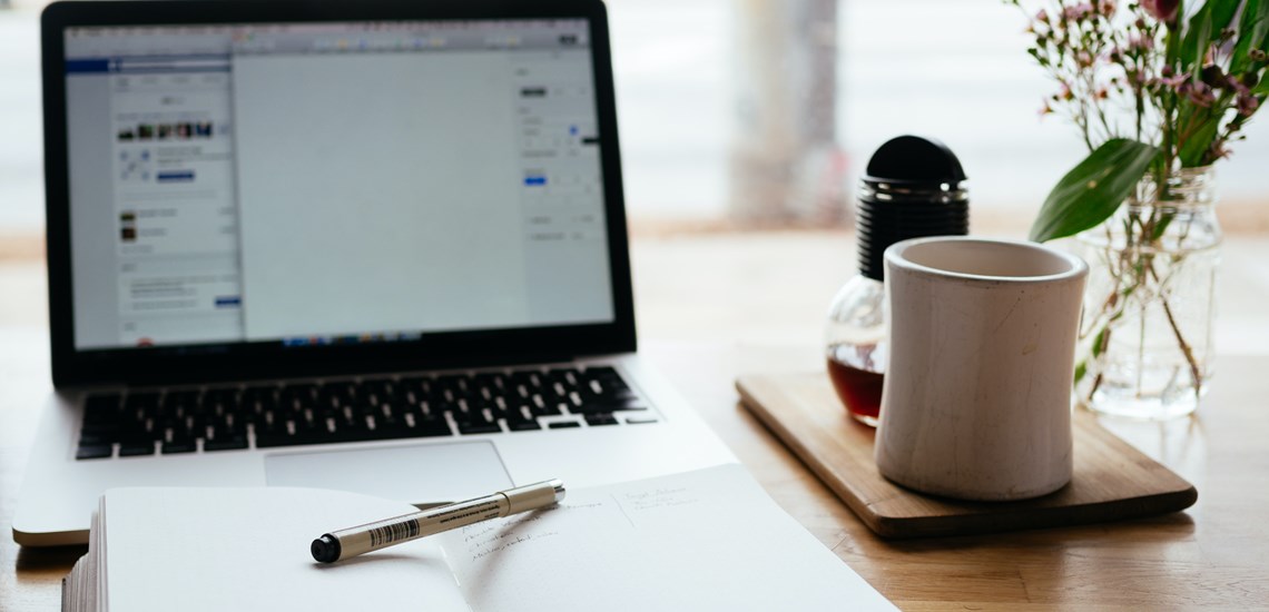 working-from-home-laptop-desk-notepad-referral